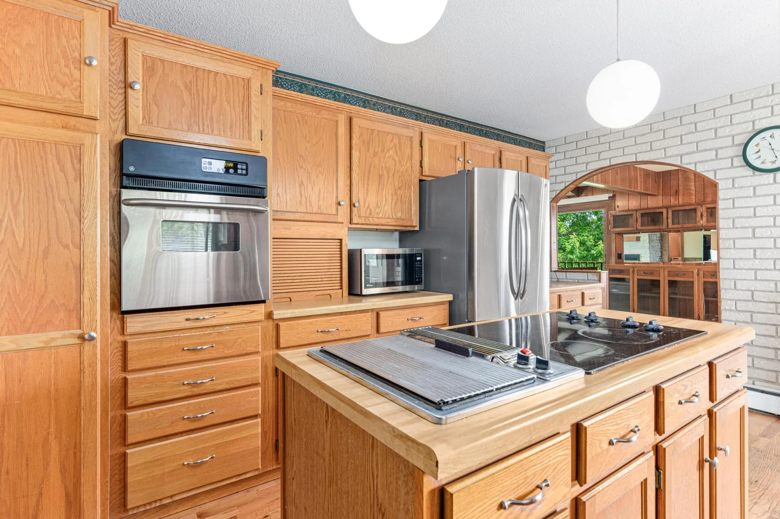 The abundant storage includes a pantry cabinet, an appliance garage and a built-in desk at the planning center..