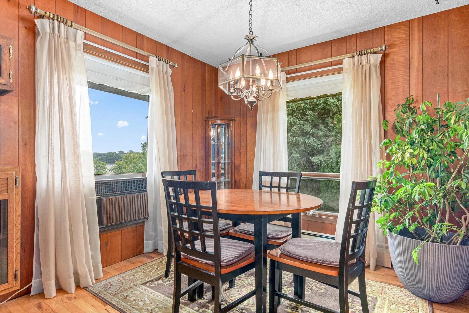 the row of arborvitae seen through the East window of the dining room creates a nice privacy screen while the North window looks out to the lake.  Oversized windows are also found throughout the other rooms in the main level.
