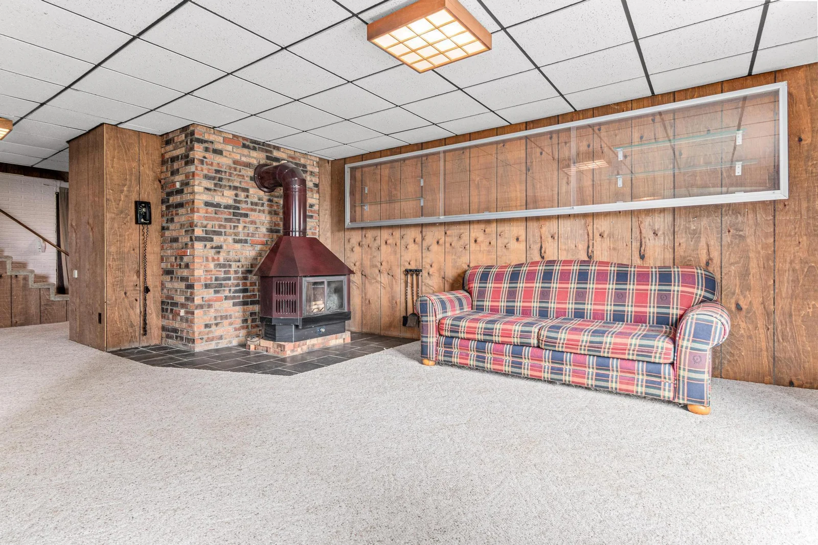 The lower level walks out to the large yard.  This large family room is a great place to relax after a long day on the lake. During the colder months, cozy up with hot chocolate next to the freestanding wood-burning fireplace.