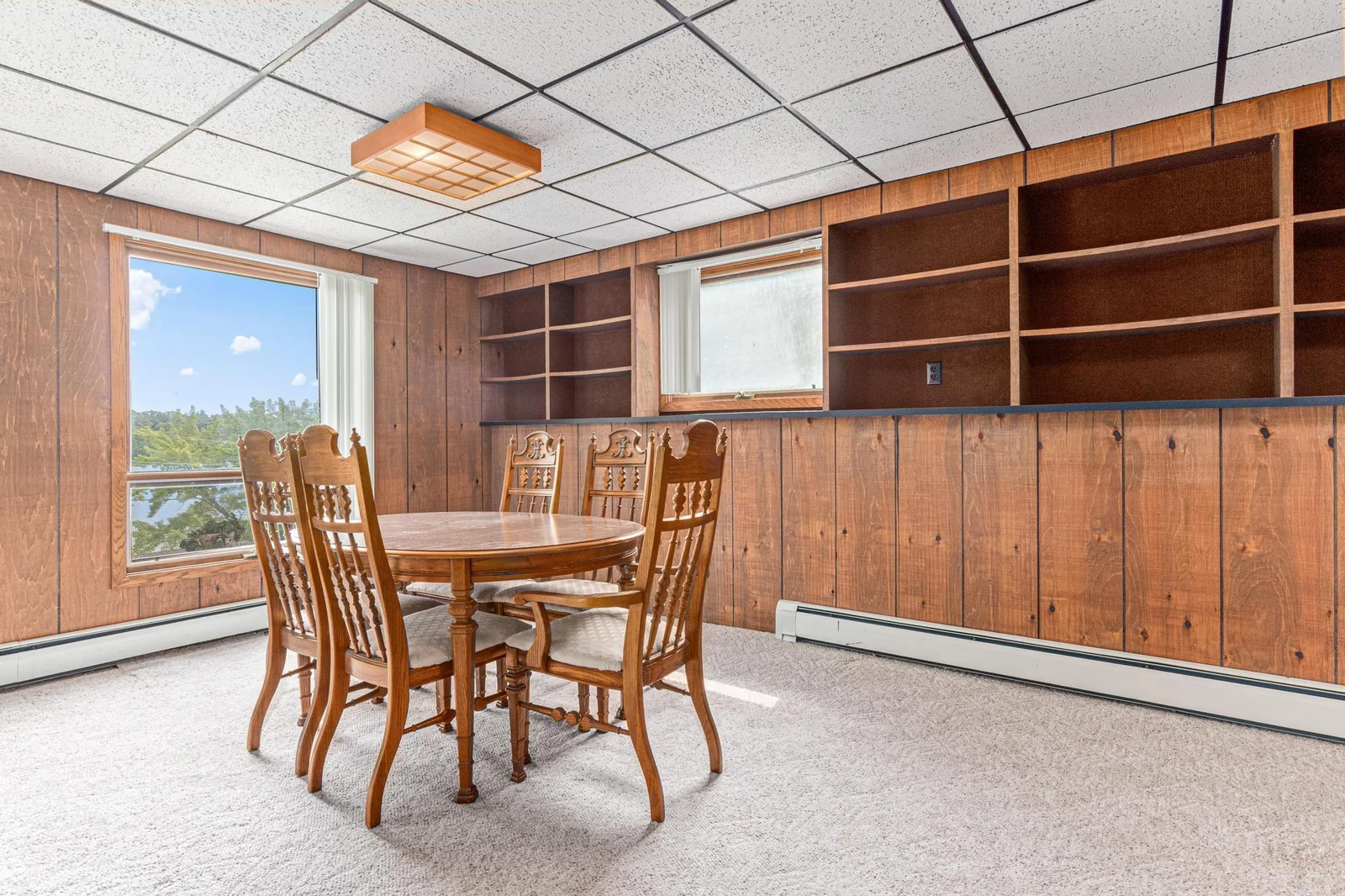 Opposite view of the family room has plenty of space for a dining table.  Large windows showcase the lake view.