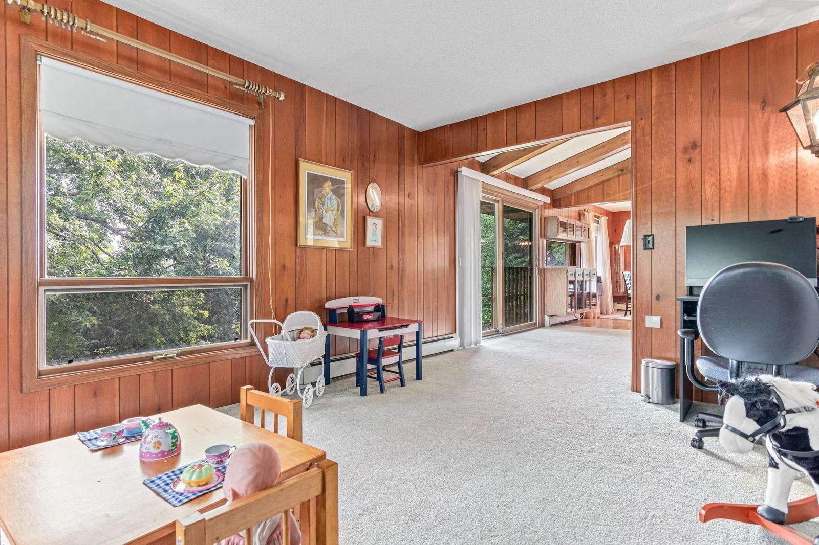 The den, currently used as a playroom and office space, has two large windows and would be a great TV room if you'd like the living room to have the fireplace as the focal point.