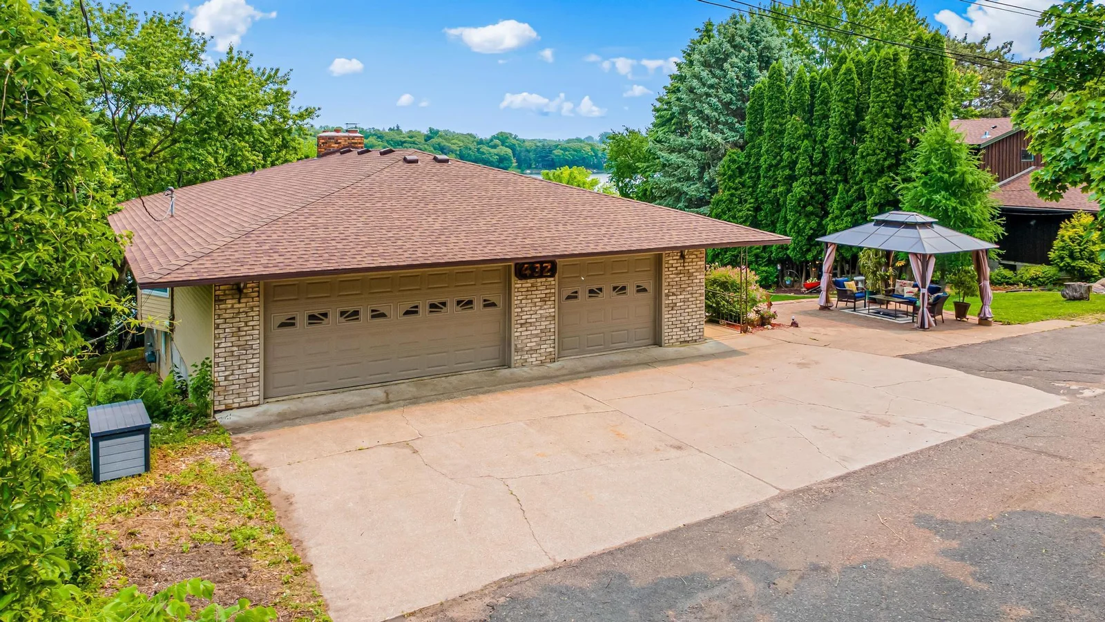 A mature row of arborvitae creates a living privacy screen between this home and the neighbors.