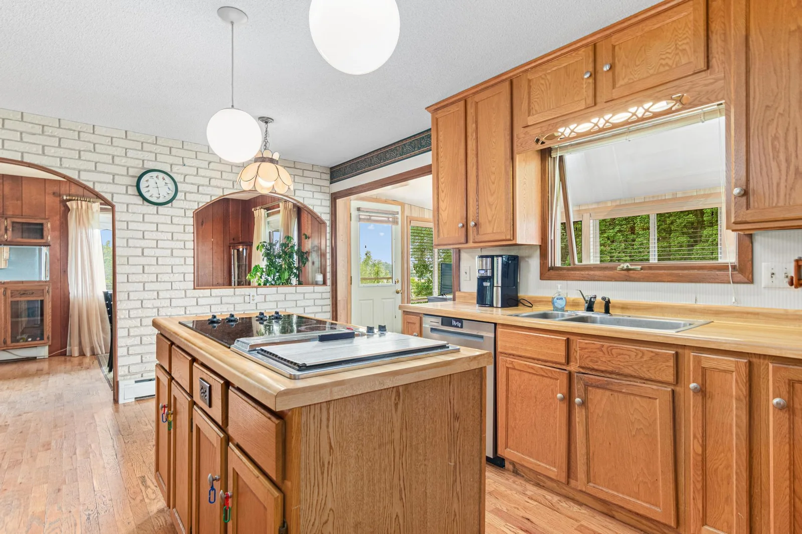 Inside the thoughtfully designed kitchen you will find an abundance of both light and cabinetry. The kitchen adjoins the sunroom, dining room and living room.