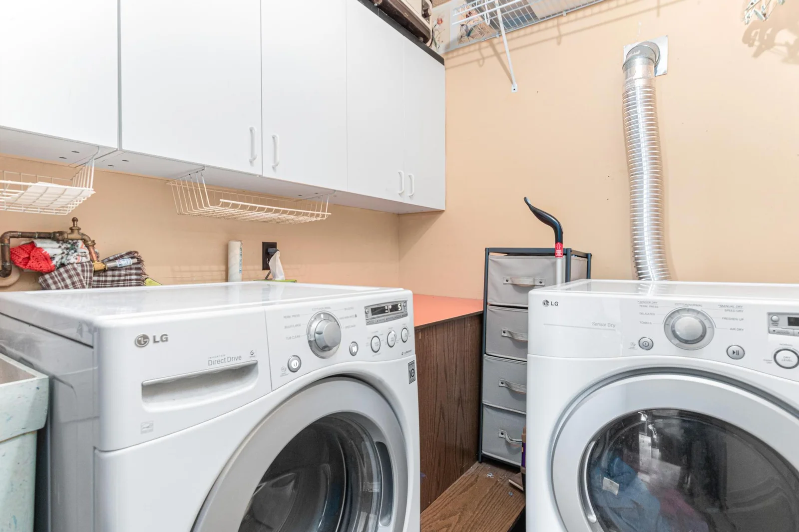 The main floor laundry room has front load washer and dryer as well as a large lundry tub and excellent storage.
