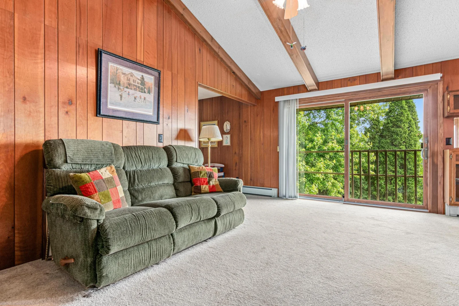 A large sliding door looks out to the private yard and the lake.