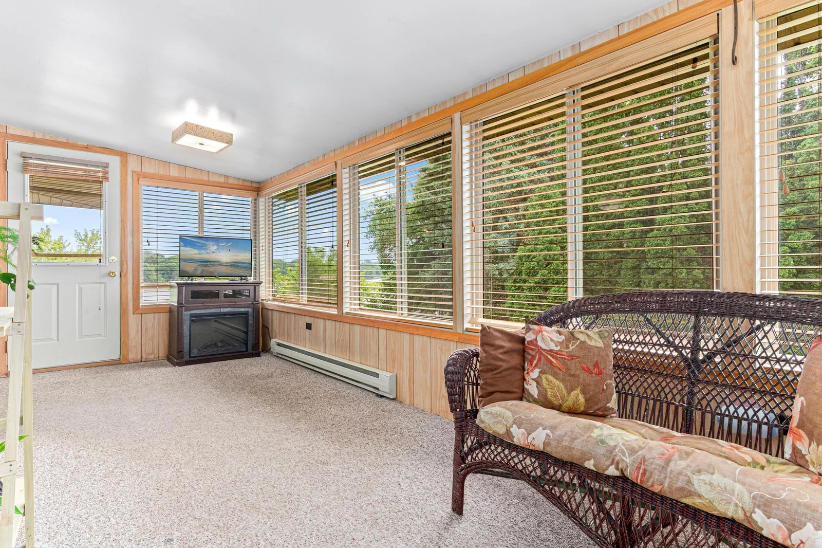 Enjoy morning coffee in the East facing sunroom with lake view seen through the North window.