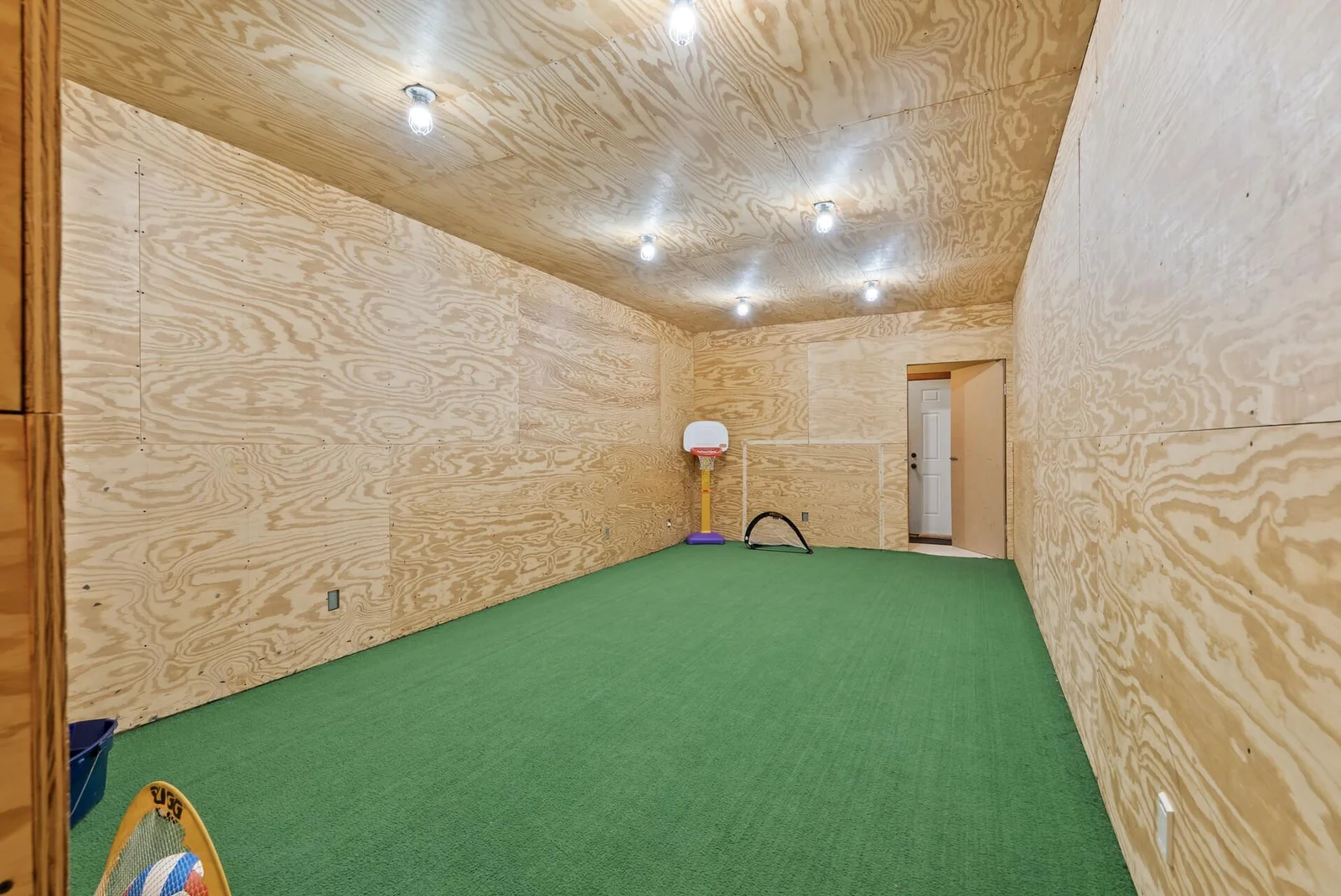 This room was designed to practice your shooting!  After soccer season roll up the turf to review smooth flooring perfect for shooting pucks!