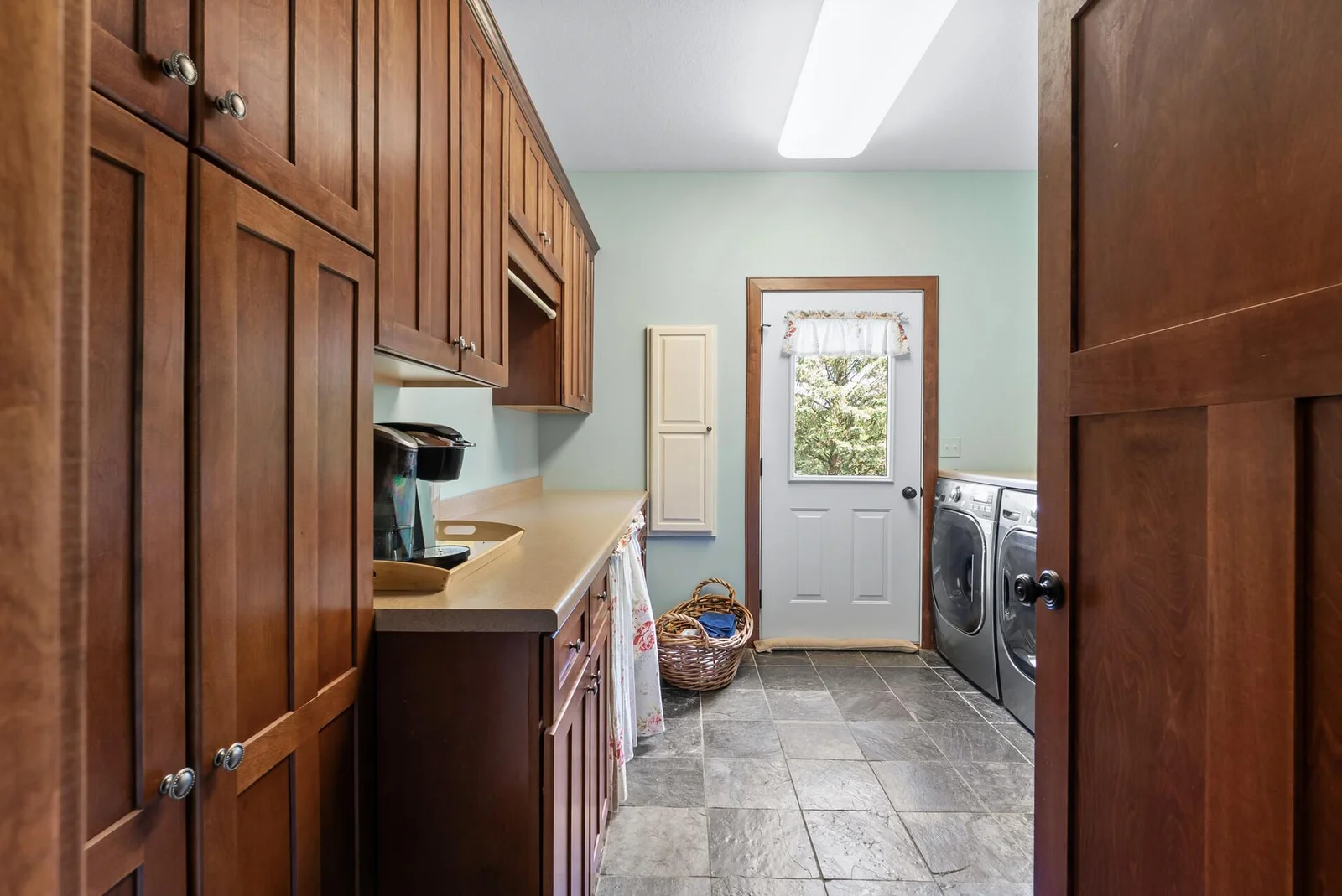 Main floor laundry with private balcony to hang dry those sheets!