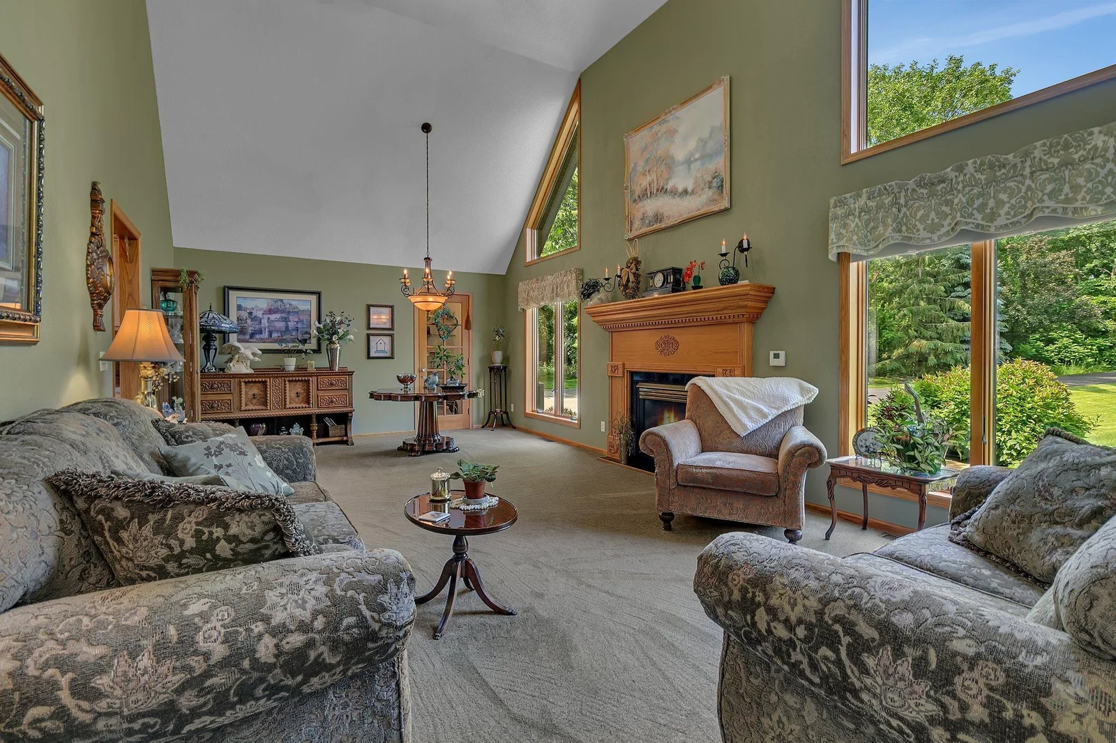 View from living room into the formal dining area with the built in china closet! The large windows allow for some of the best nature watching. Wall separating the kitchen can be removed to allow for an open concept.