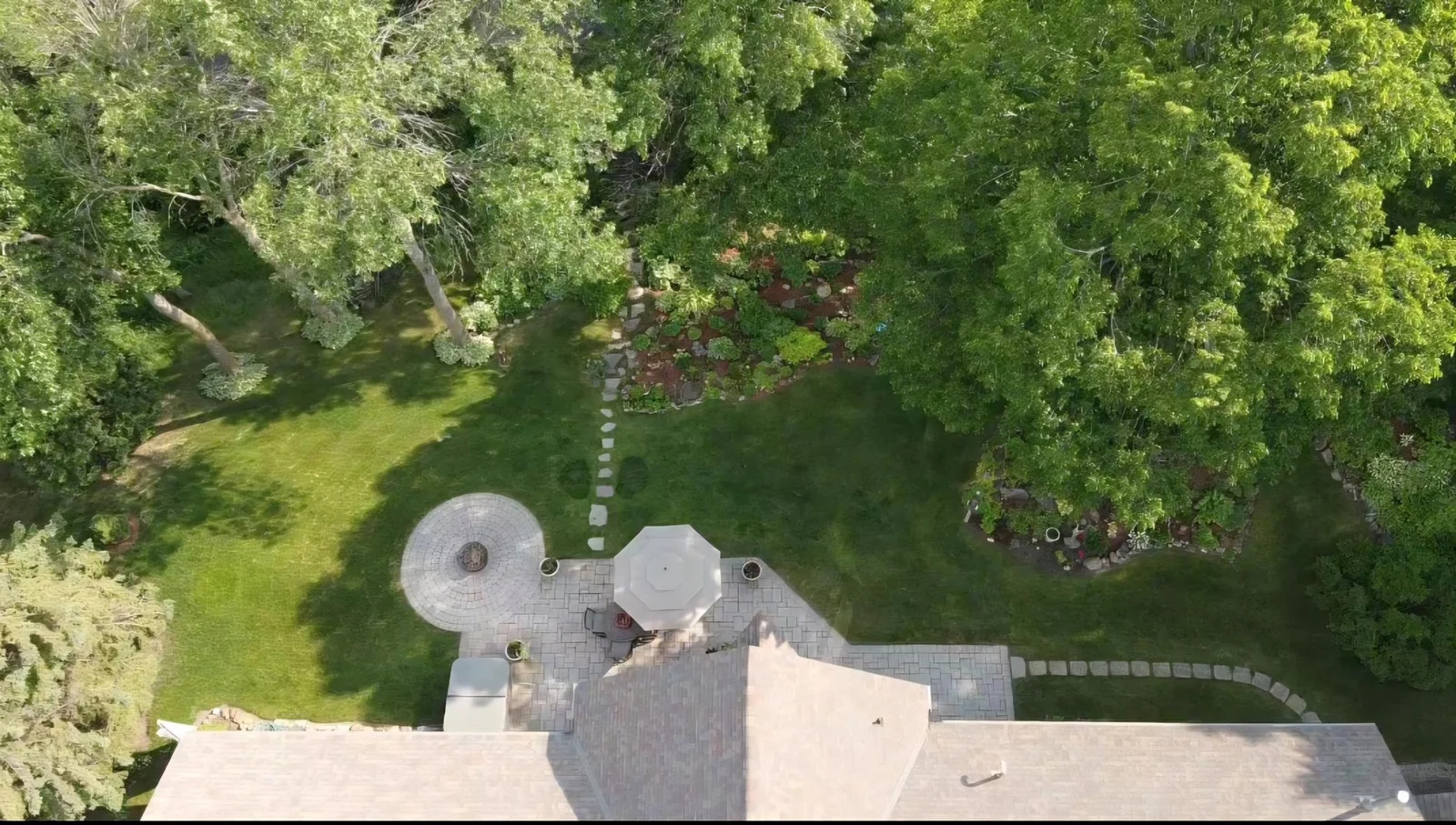 View showing the paver patio, stepping stone walk way & perennial gardens lakeside. This yard is a gift that keeps on giving!