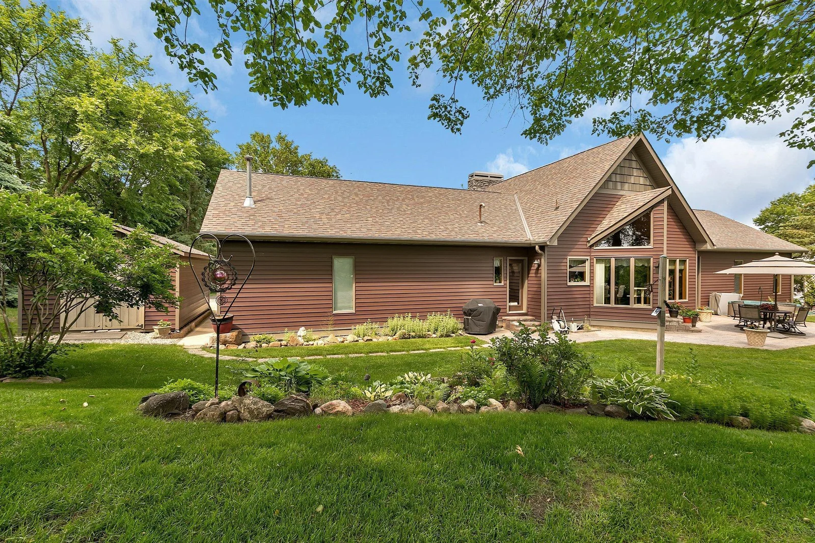 Enjoy the perennial gardens & nice large level area in the yard is perfect for yard games.