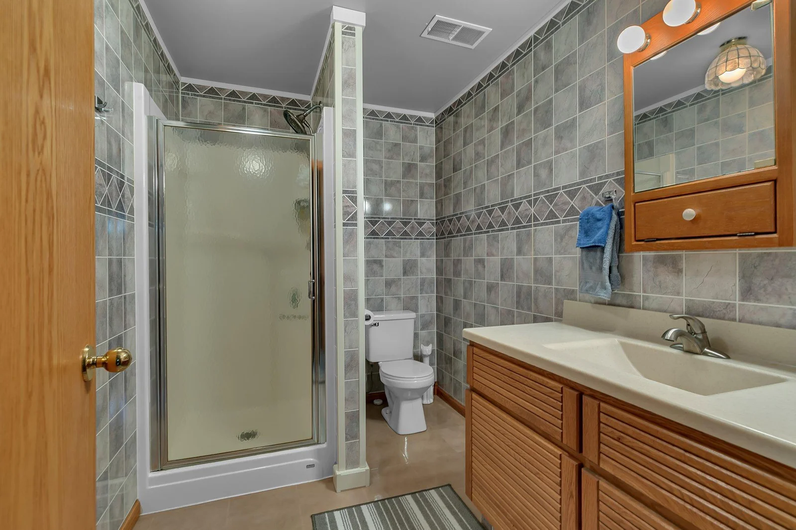 Lower level 3/4 bath with epoxy floor.