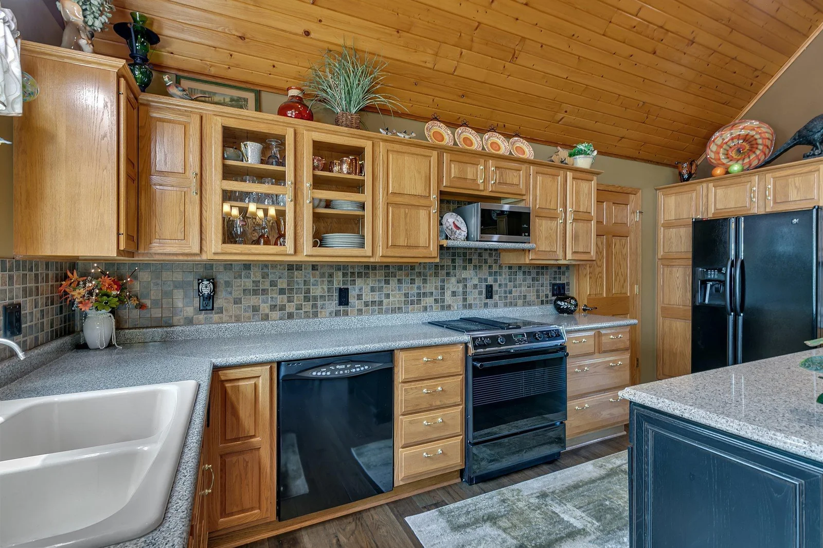 Kitchen is nicely laid out for all your culinary needs. Beautiful backsplash, generous amount of storage, and ample counter space. Jenn-Air range with downdraft venting and soon a new refrigerator.