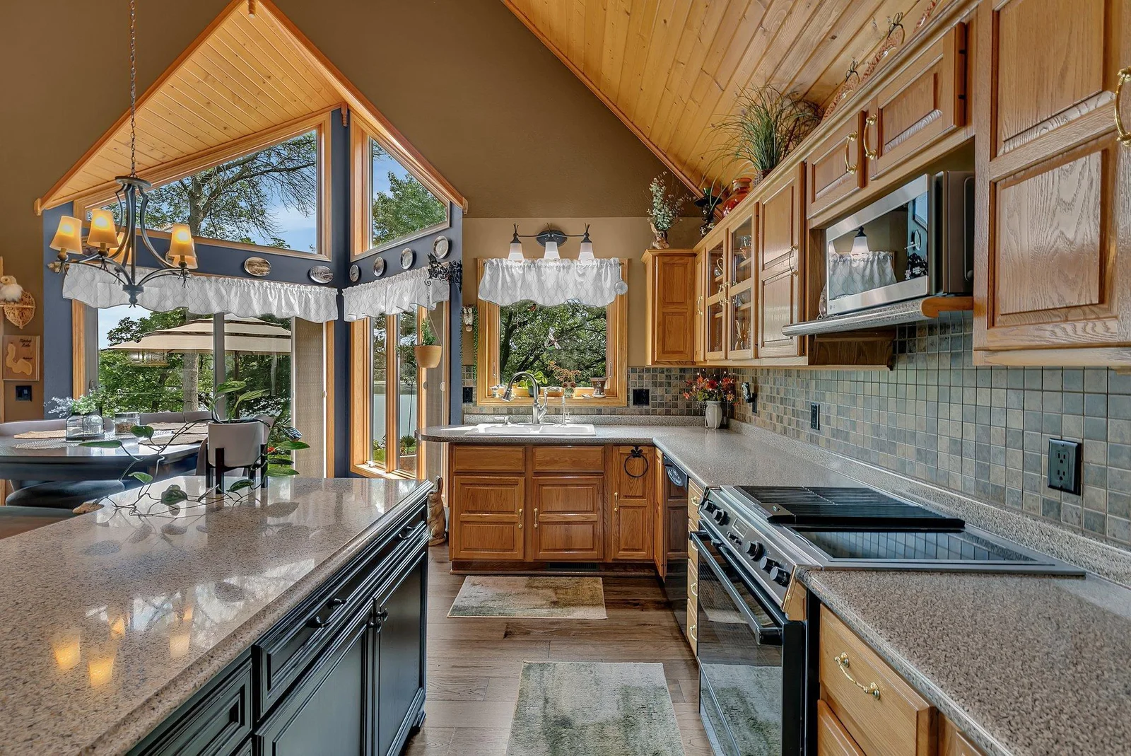 Large kitchen with ample storage and counter space. Large windows allow for some of the best lake views around. This custom build home is stunning!