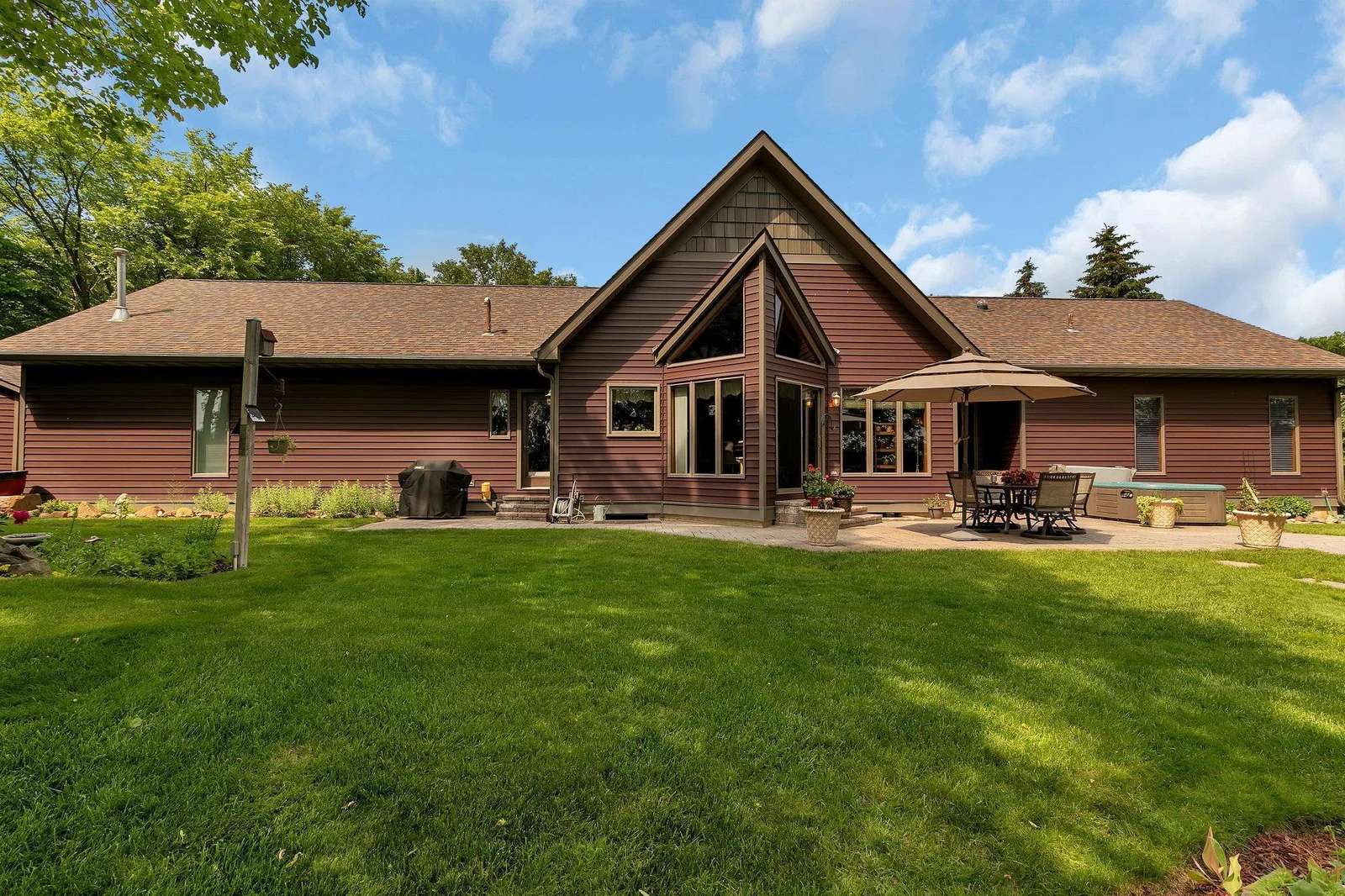Enjoy Summer days on the lakeside paver patio. Or your evenings int he hot tub (which stays with the property!). Home is maintenance free & has steel seamless siding, gutters & gutter guards.