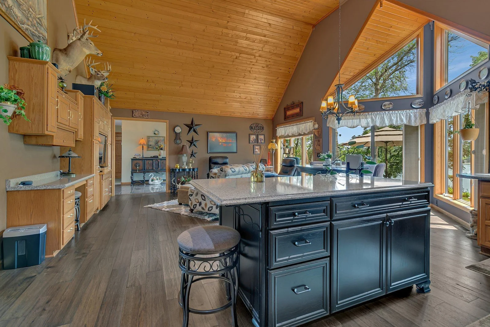 Kitchen/living space has recently installed engineered hardwood flooring, vaulted knotty pine ceilings and gorgeous large windows.