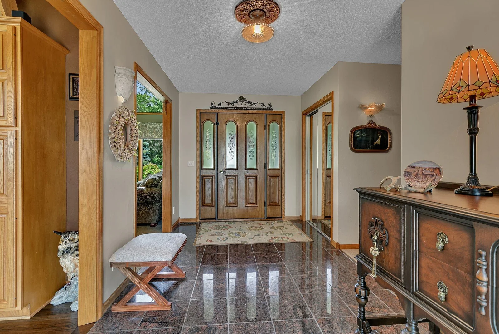 Large welcoming foyer with large coat closet & granite tile floors. This custom built home is simply amazing throughout!