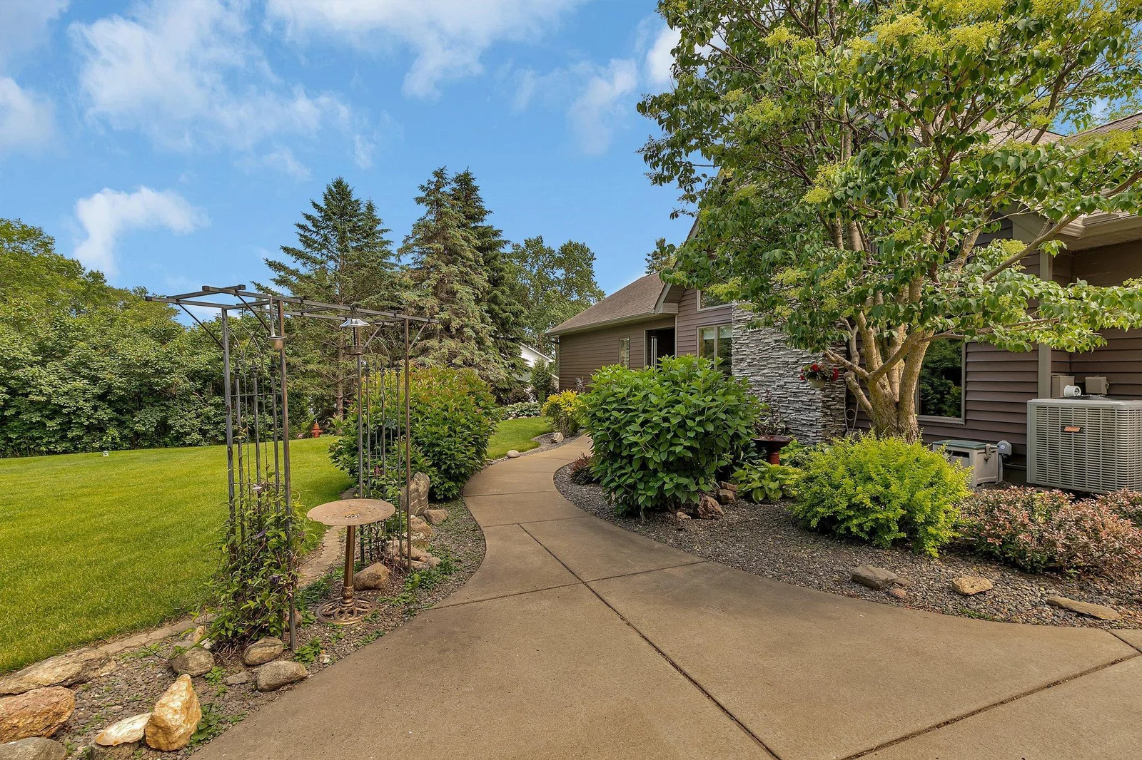 Welcoming sidewalk surrounded by flowers & bird feeders. Wildlife abounds throughout this property.