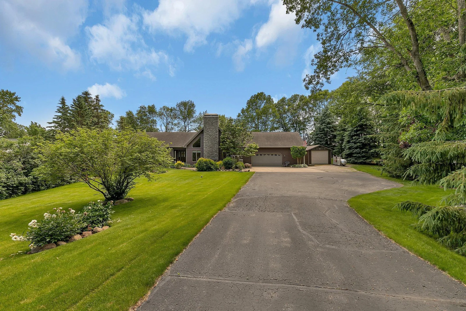 Long private asphalt driveway offers ample parking space.