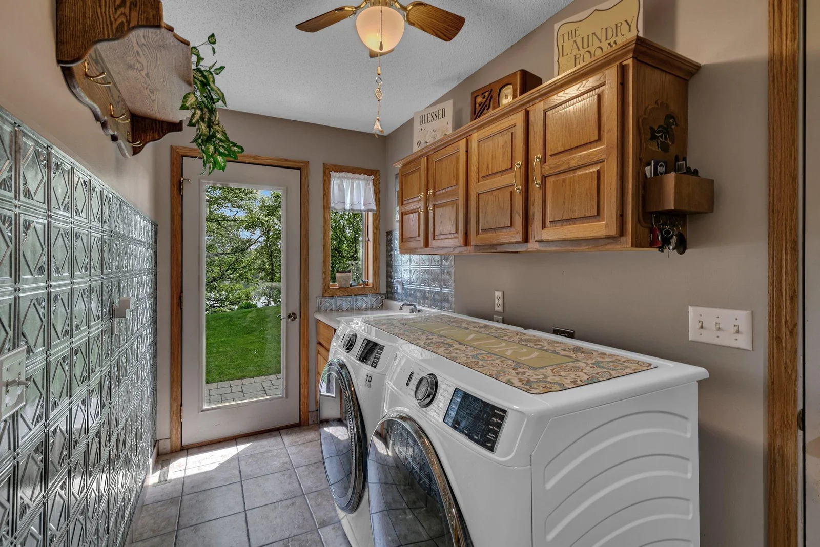 Mian level laundry room with sink & ample storage. Door allows access from the paver patio for all your gardening needs.
