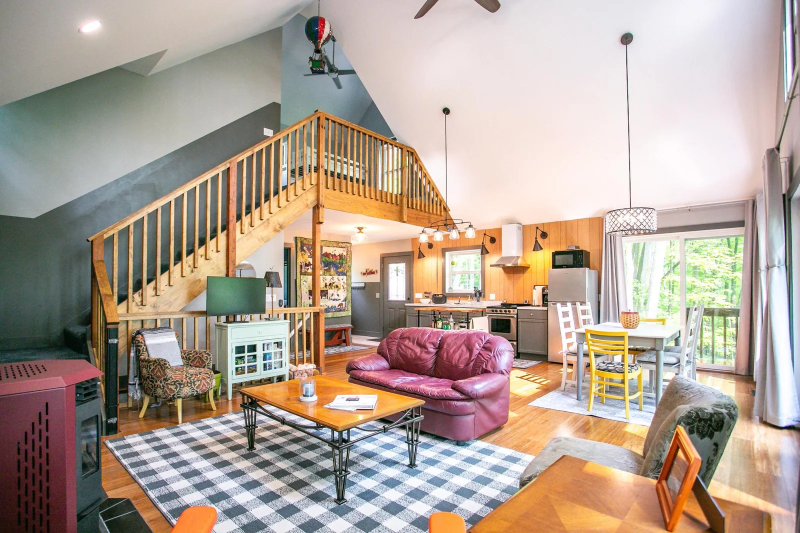 Living/kitchen/dining and stairs to loft and upper bedroom