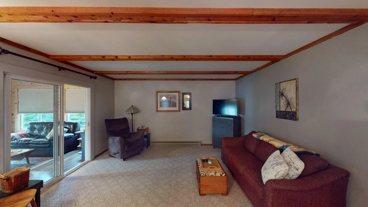 Living rm w/sliding doors to 3-season porch