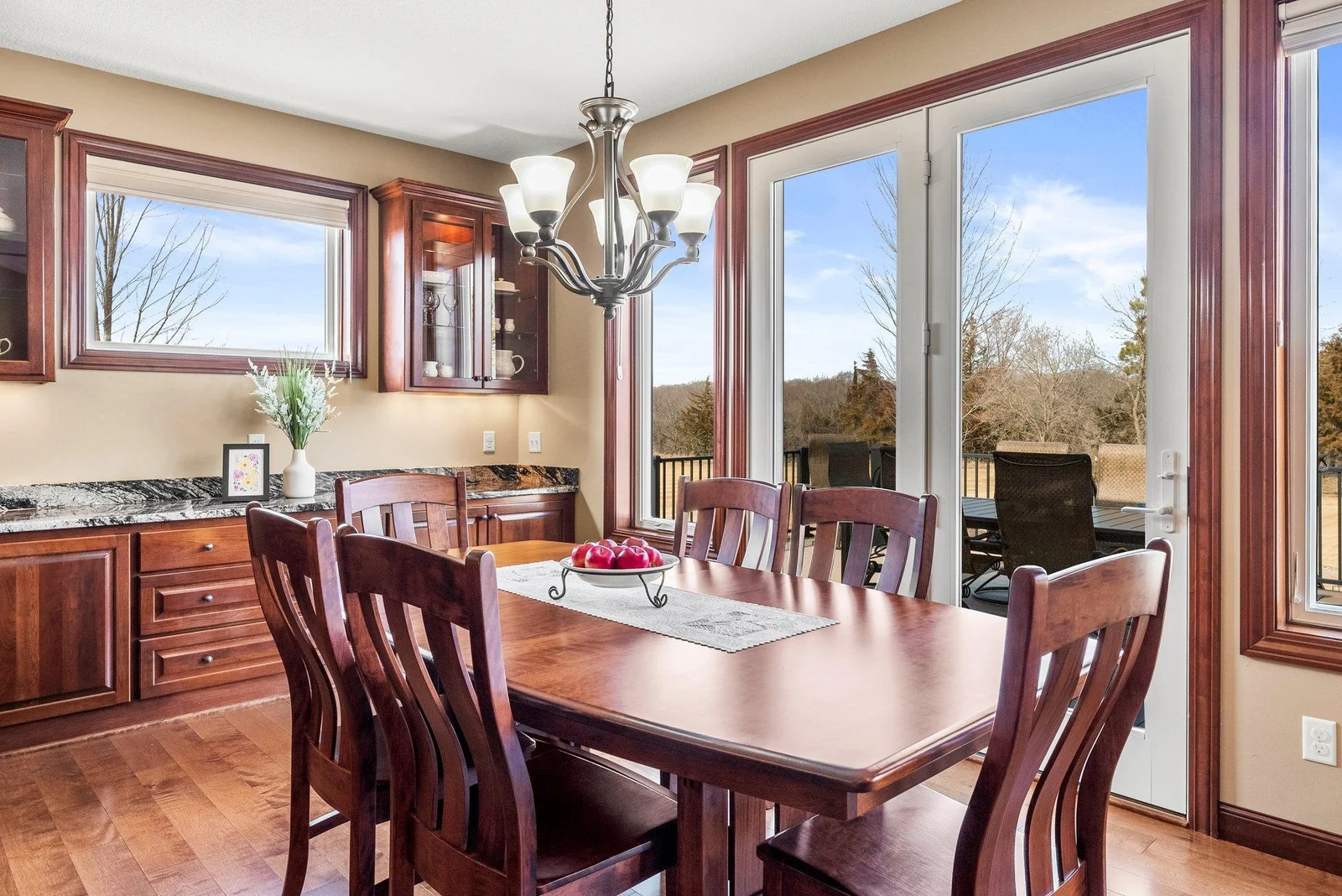 The dining room offers a perfect setting for both casual and formal dining. Glass doors open directly to the maintenance-free deck, where you'll enjoy tranquil views of the expansive backyard.