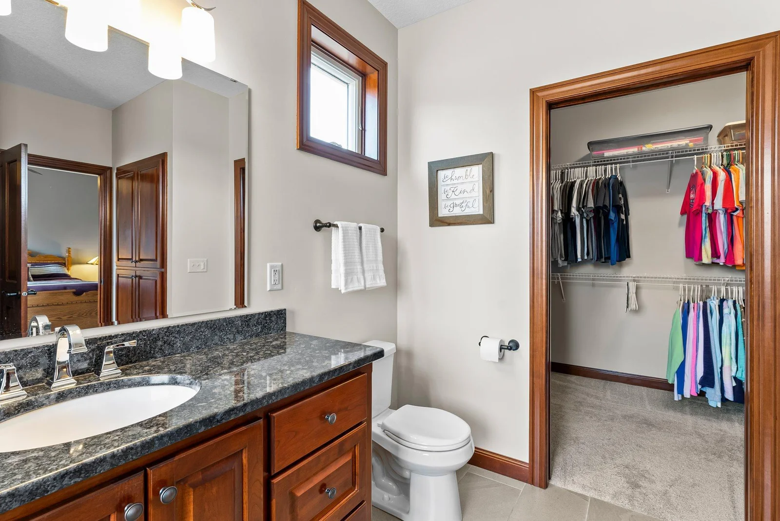 The bathroom leads directly into the oversized walk-in closet, providing ample storage space for all your wardrobe essentials.