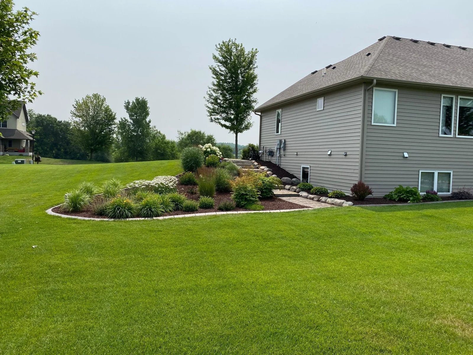 The home sits on just over an acre of beautifully landscaped grounds that create an impressive curb appeal.
