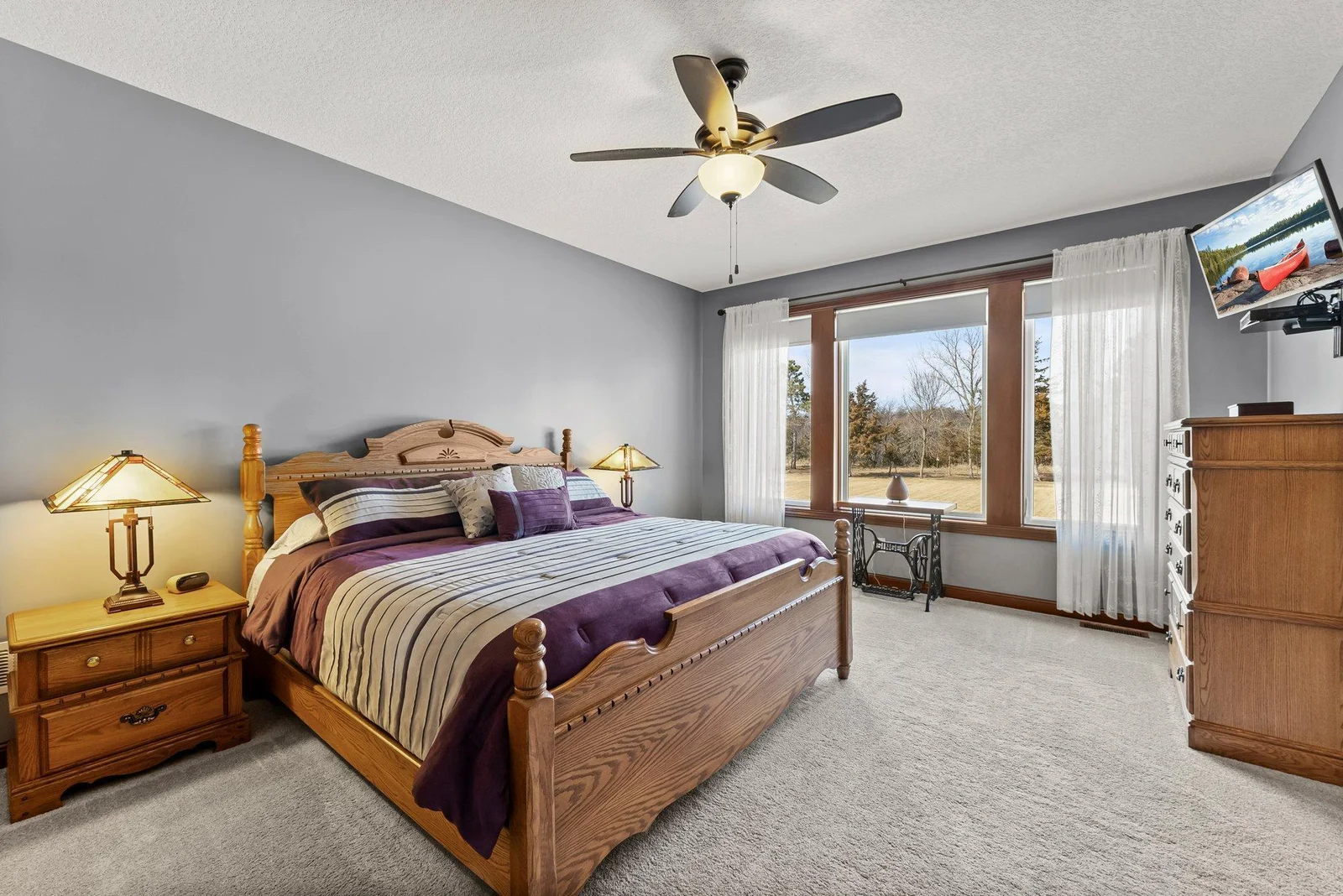 The primary suite is a true retreat, offering serene views of the backyard and a spacious layout.
