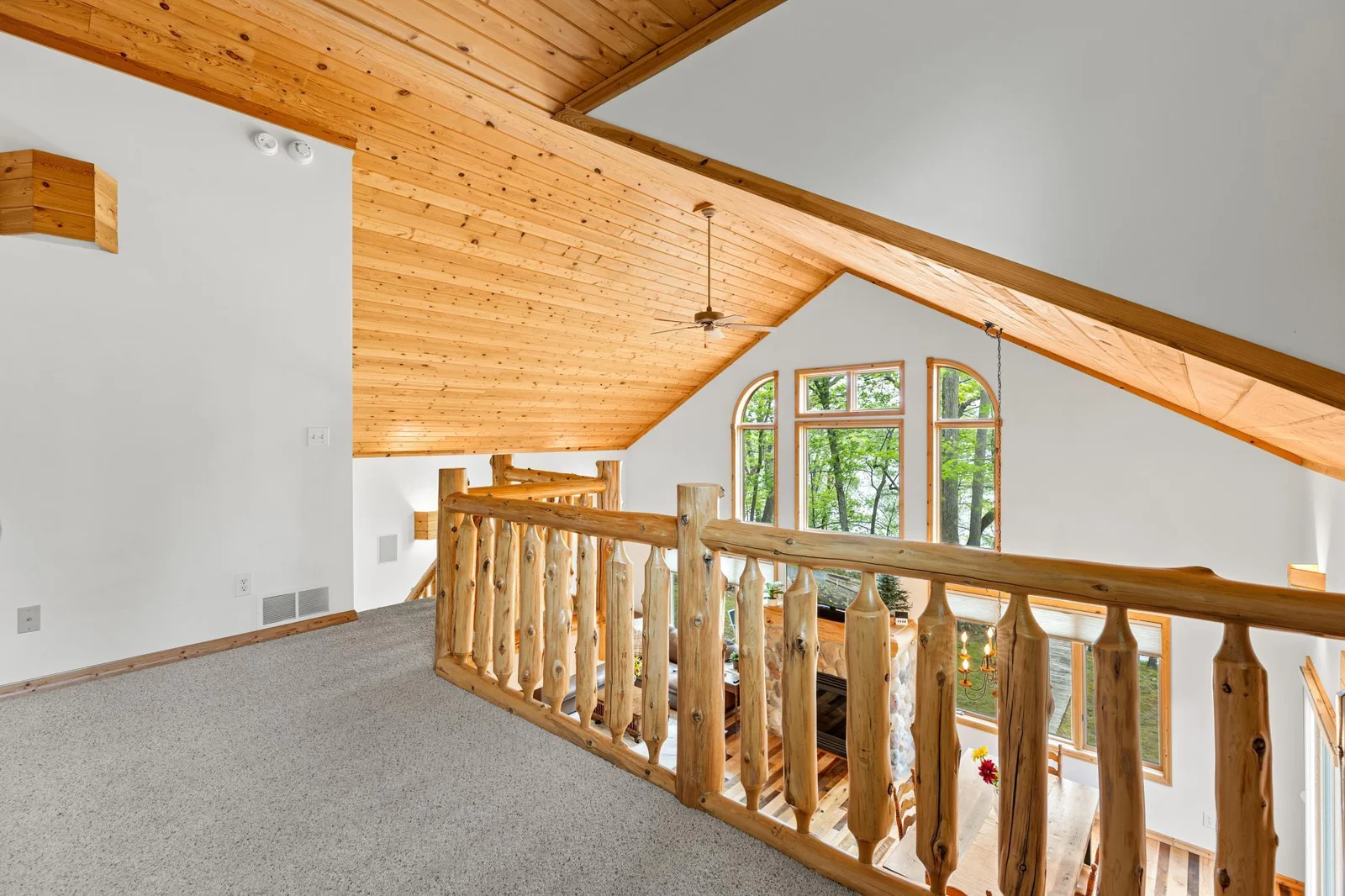 Upper Loft area features a log railing