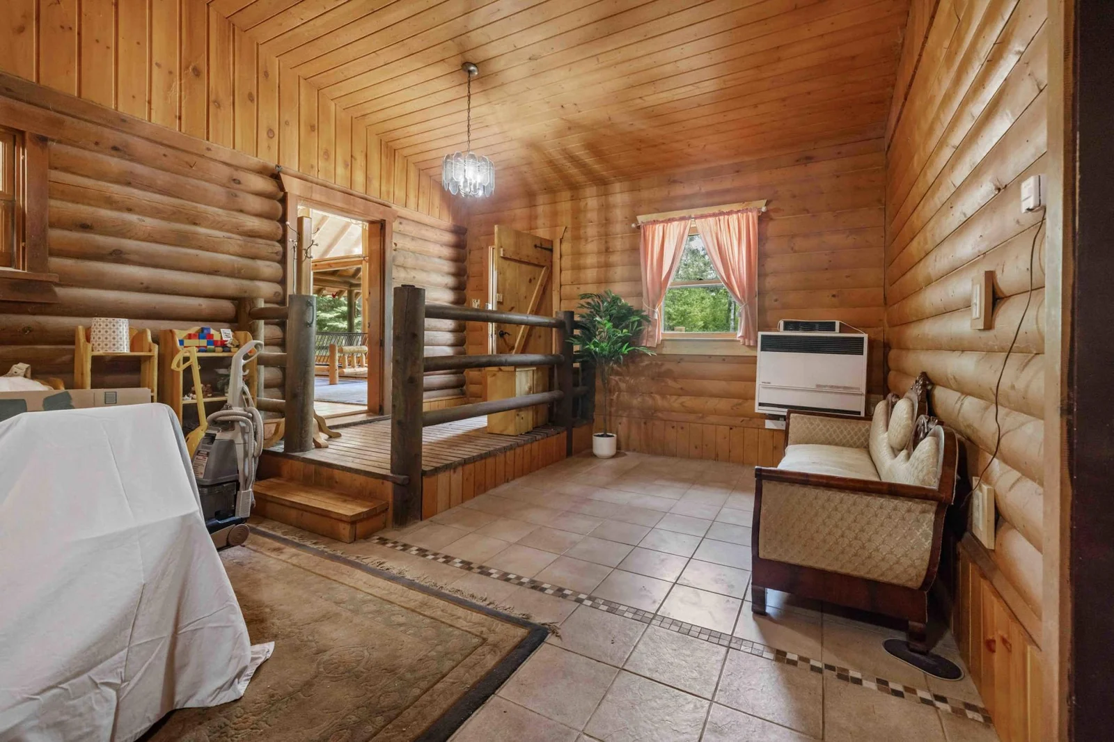 Step inside to the breezeway! Breezeway leads to a main floor bedroom, sitting room, and bathroom!