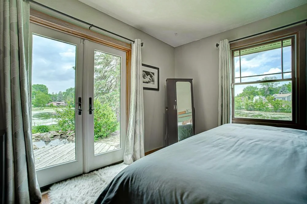 Primary bedroom with French doors to the deck.