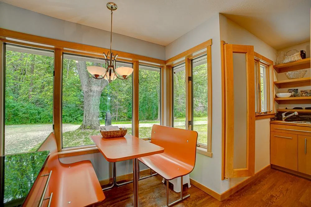 Charming vintage booth creates a breakfast nook.