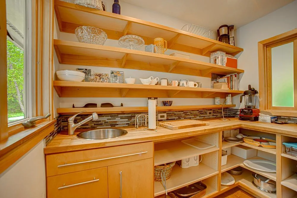 The pantry off the kitchen has a prep sink & plentiful storage