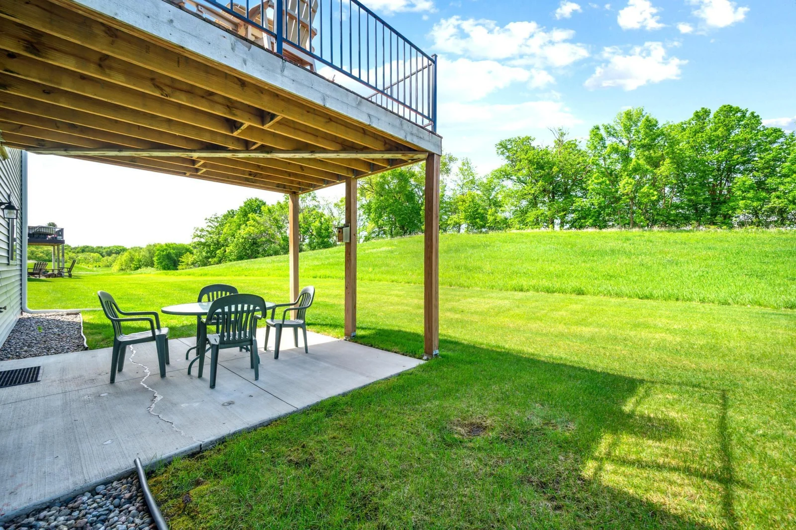 Patio off walkout lower level with notable rear yard views.jpg