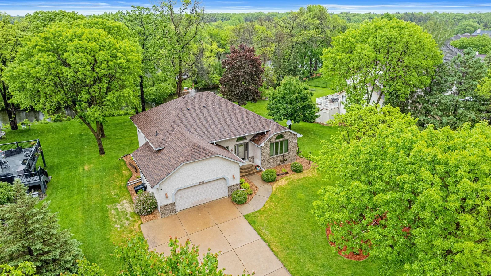 Beautiful lilac bushes and landscaping surround the house
