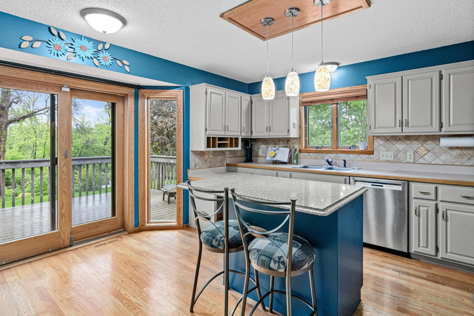 View of the kitchen and patio door leading to the low maintenance deck