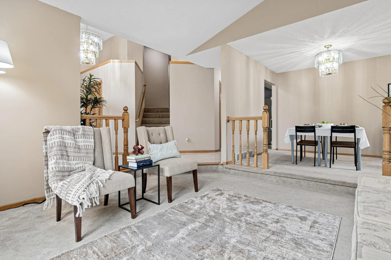 View from the sitting room looking at the stairs to the upper level bedrooms and dining room to the right