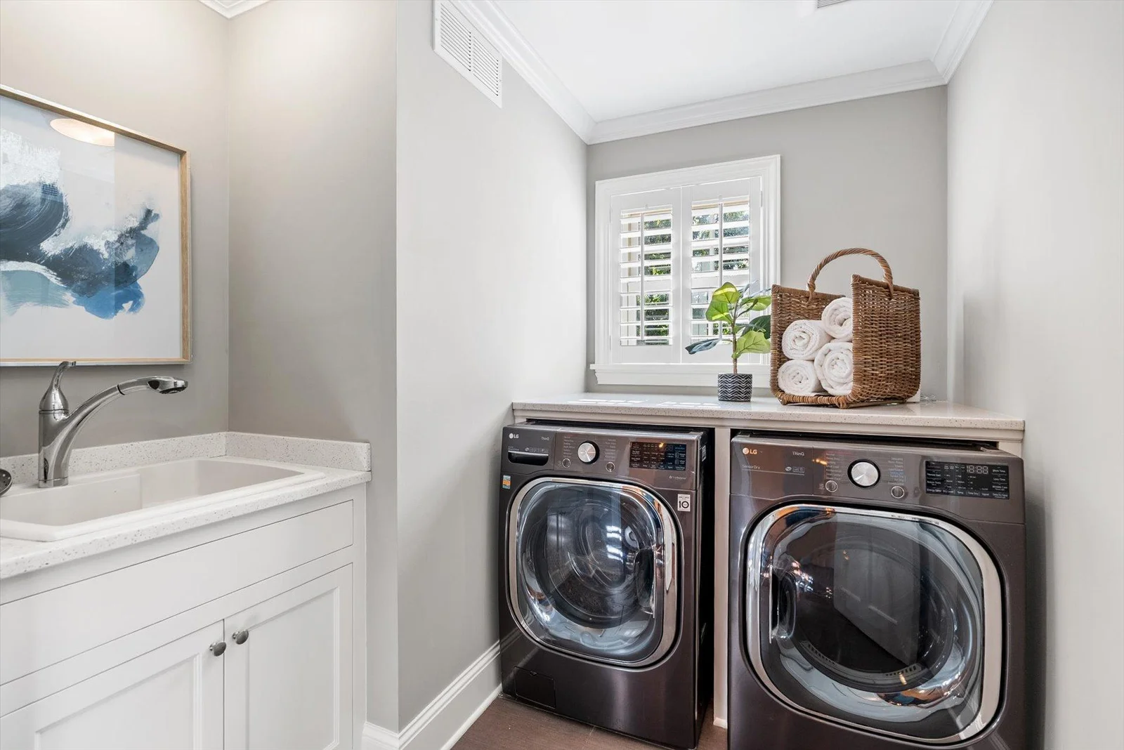 Laundry room with a wash tub conveniently located on the second floor. Washer and Dryer new in 2023.