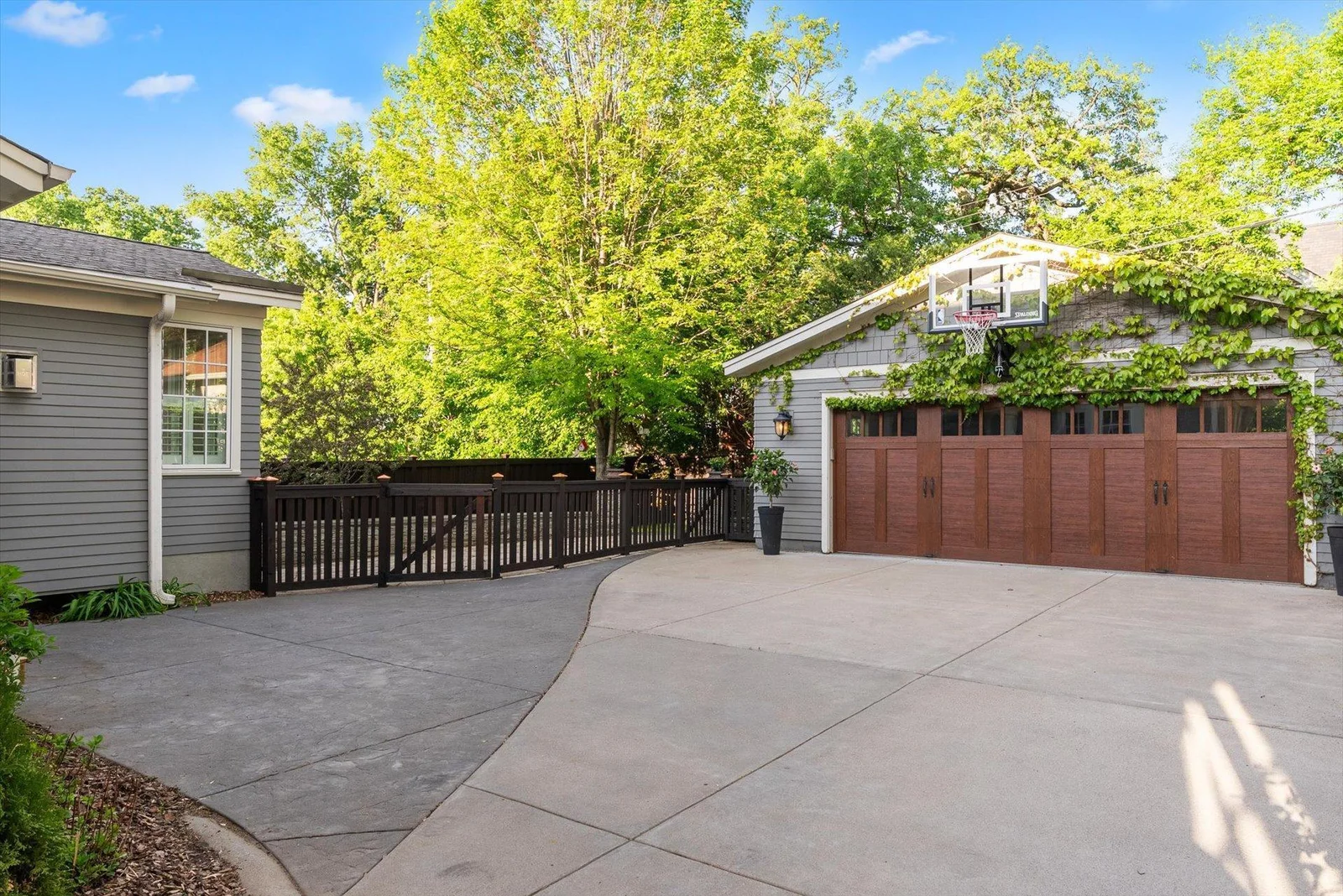 Wood-like metal garage door and conrete driveway.