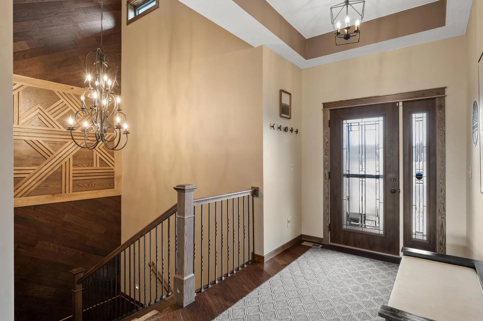 Your guests will be wowed as they enter through your custom decorative glass inset door and admire the 24' ceiling and gorgeous one of a kind wood accent wall in the staircase.
