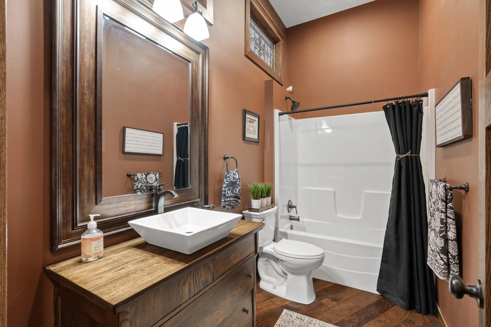 So many brilliant designs in your main level 3/4 bathroom. From the high ceilings and unique stained glass feature to the vessel sink on the antique vanity.
