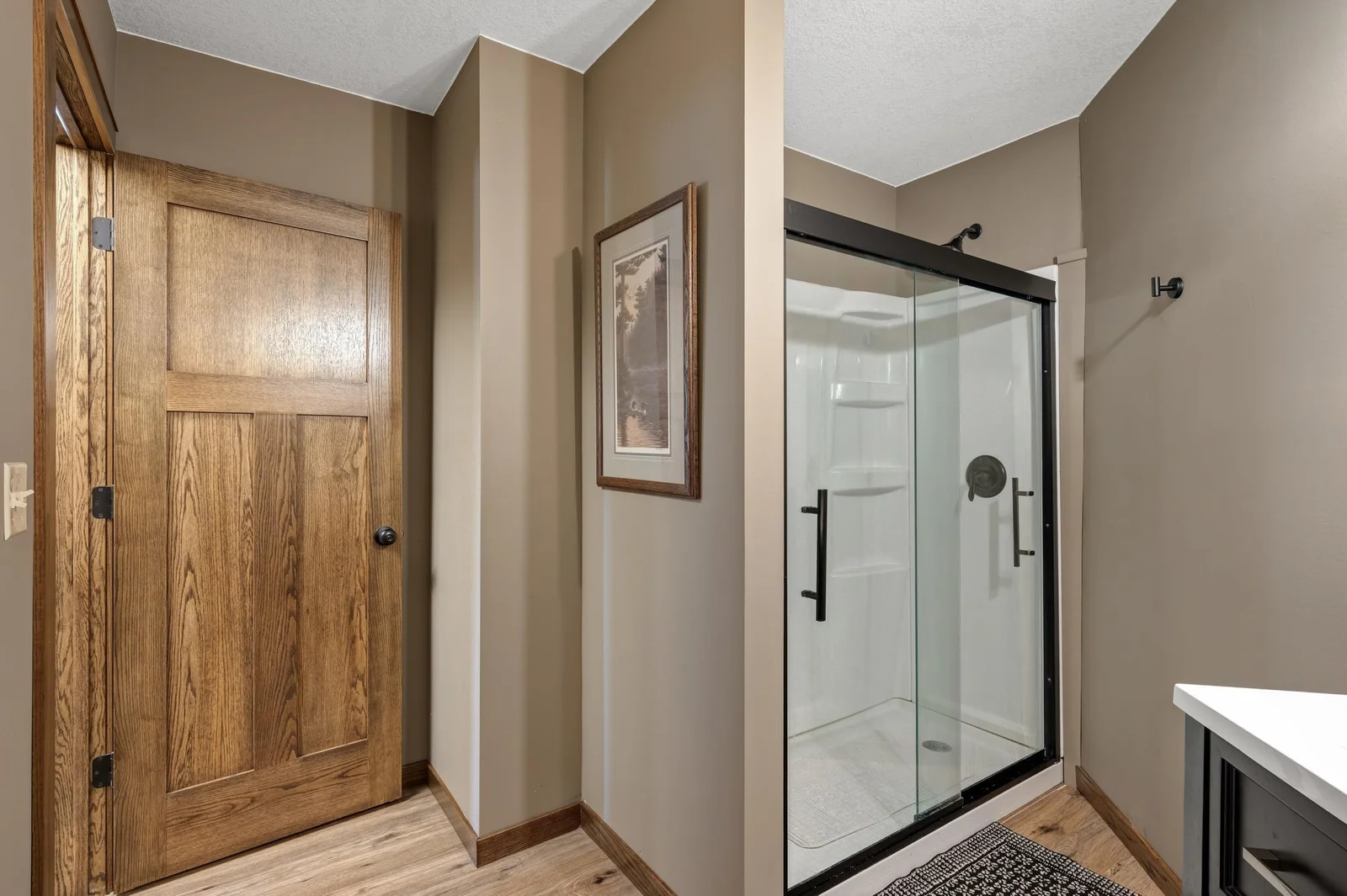 Another 3/4 bathroom on the lower level with a beautiful glass door shower.