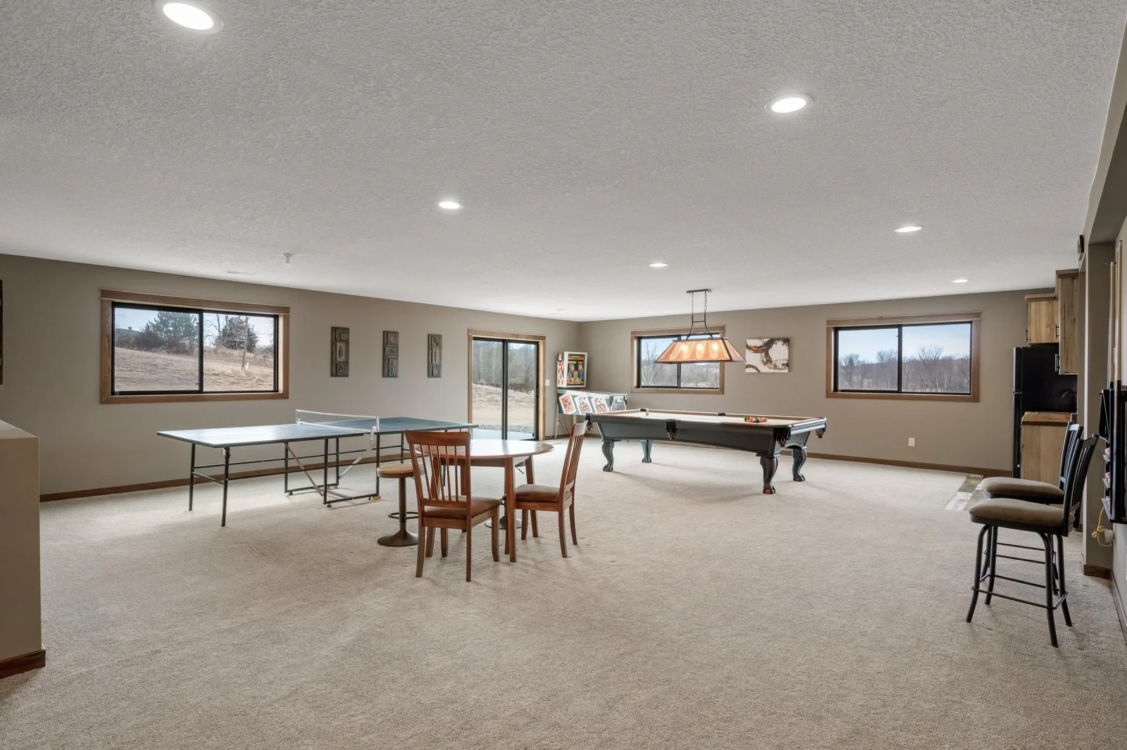 Plenty of room for all kinds of games and activities in the game room. Pool, ping pong, cards, and more! The multitude of windows give you panoramic views and your sliding glass door leads out to the patio.