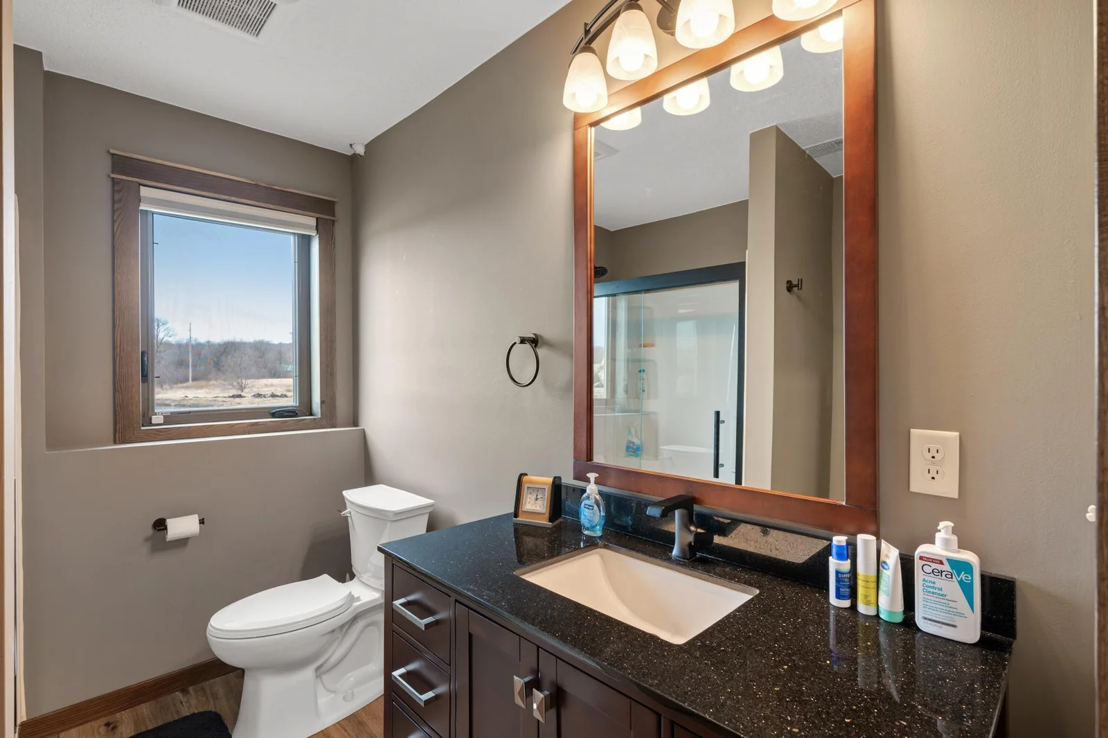 3/4 bathroom on the lower level. The solid wood vanity offers a beautiful granite top.