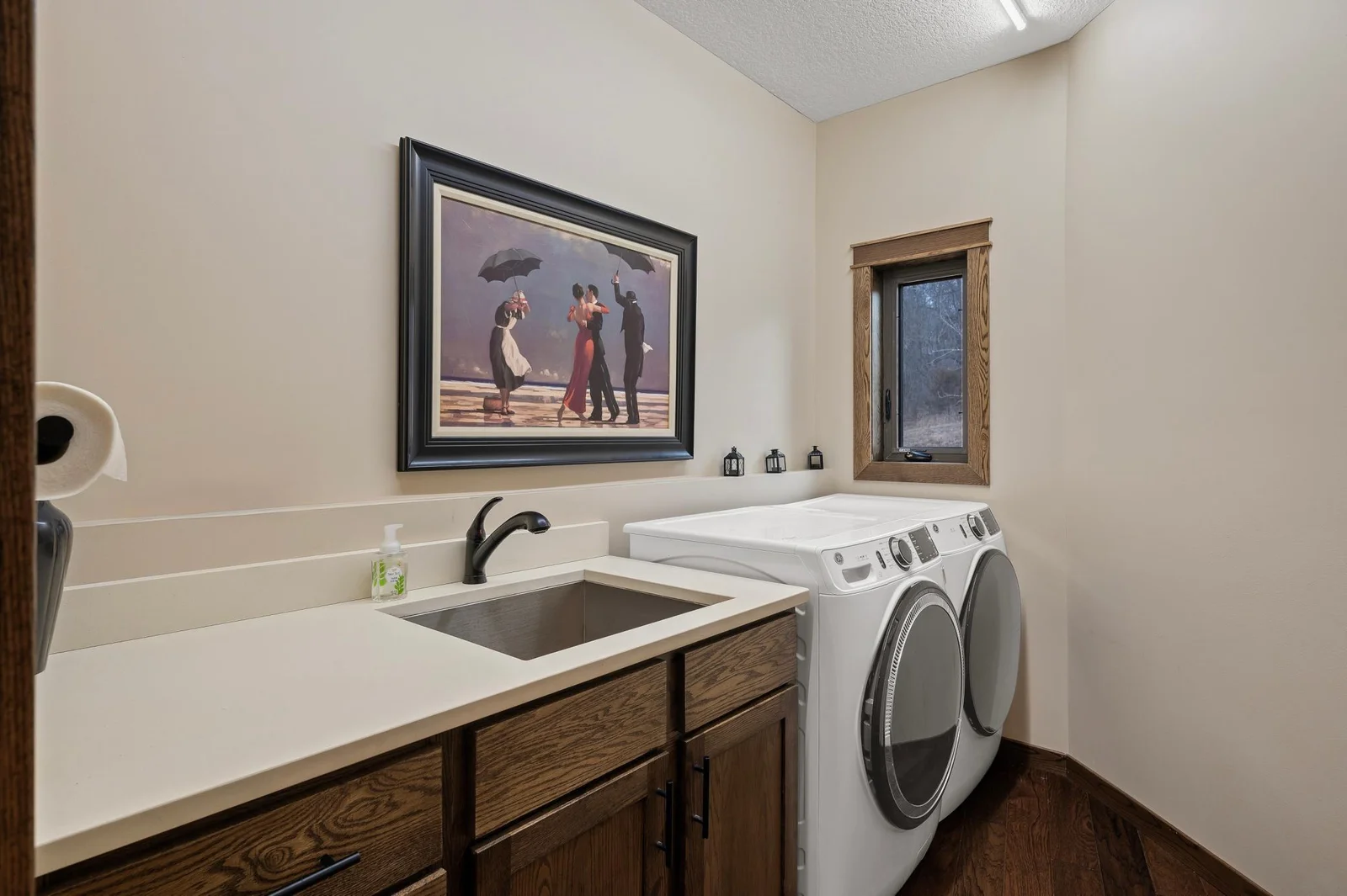 All of your living needs are met on the main level including laundry. Convenient counter space for folding and sorting, cabinets for storage, and large undermount sink for your extra cleaning needs.