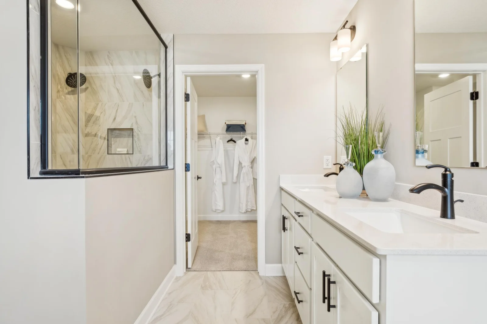 Photo is of the actual model. An extension of the primary bedroom, this private and spacious bath contains a double-vanity, a soaking tub, a serenity shower and a walk-in closet.