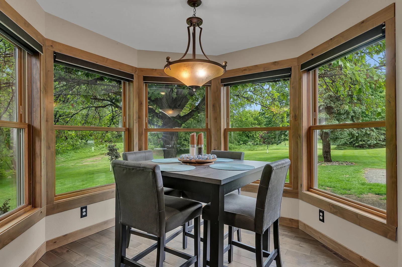 Enjoy meals in a sunlit dining cove that adds warmth and character to the home.