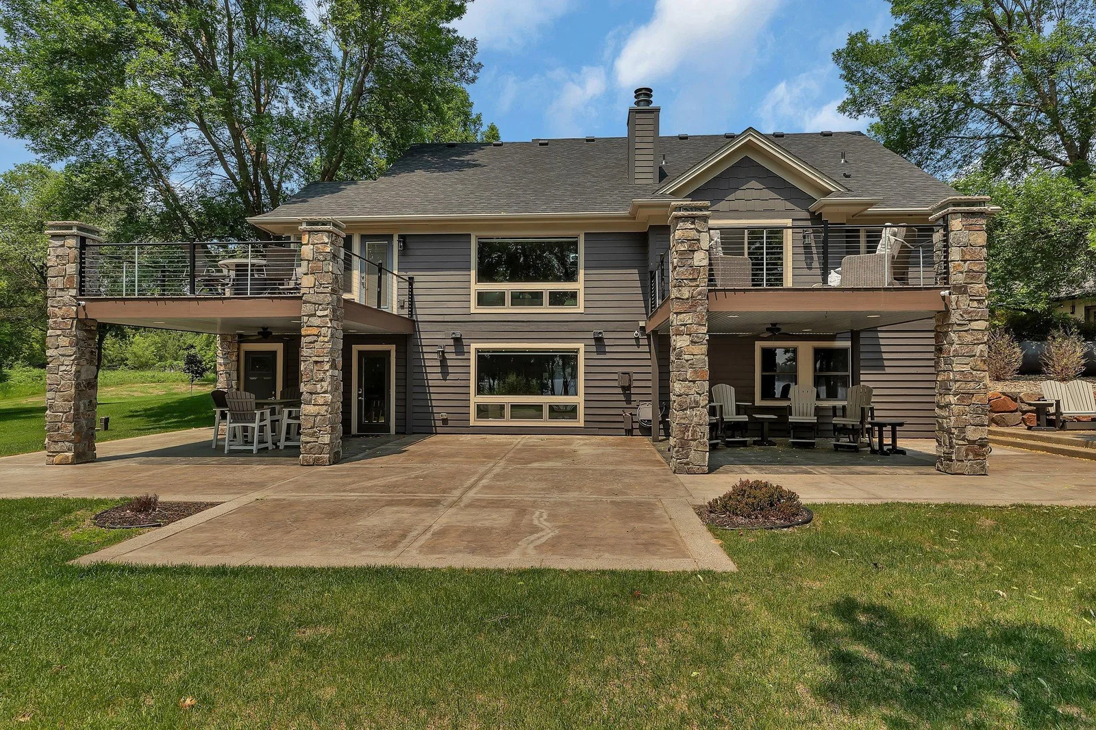 Beautiful outdoor space with maintenance-free deck and stamped concrete patio.